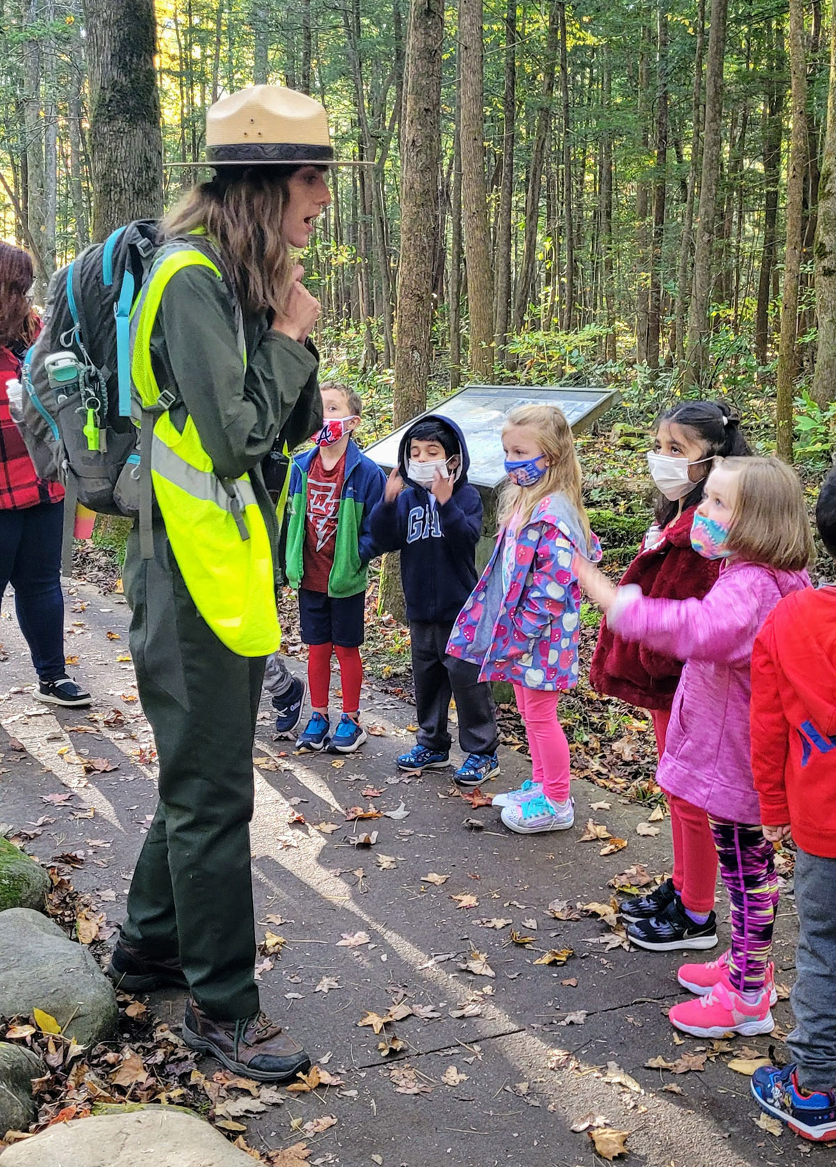 Education park ranger Jessie Snow Neeley teaches a group of young PAC students about their five senses on a sensory hike in Great Smoky Mountains National Park. Provided by Parks as Classrooms. 
